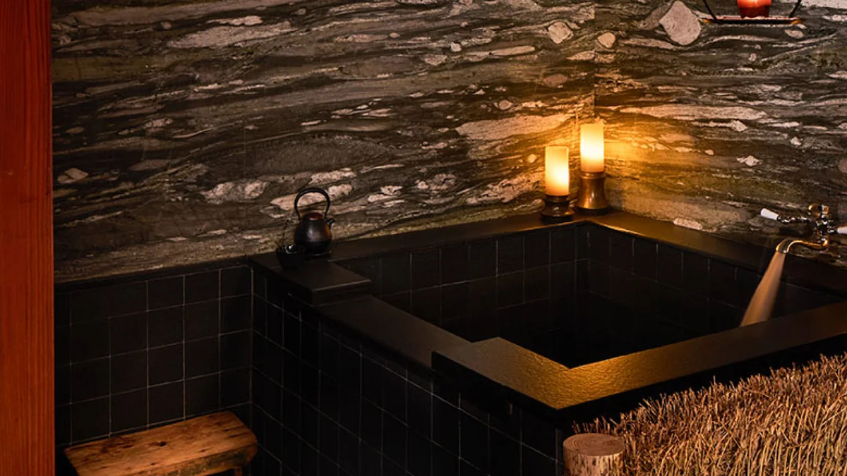 The Greenwich Hotel — the stone soaking tub beside the lantern lit pool room