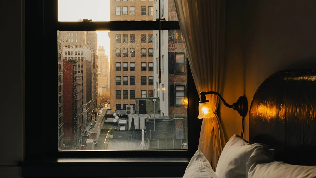 The Ned NoMad — a guest room at dusk looking over NoMad