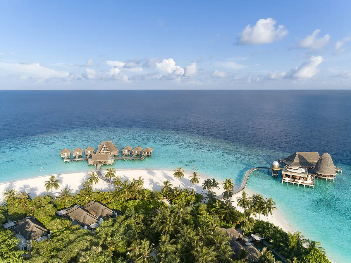 Aerial view of the island and house reef at Anantara Kihavah Maldives Villas