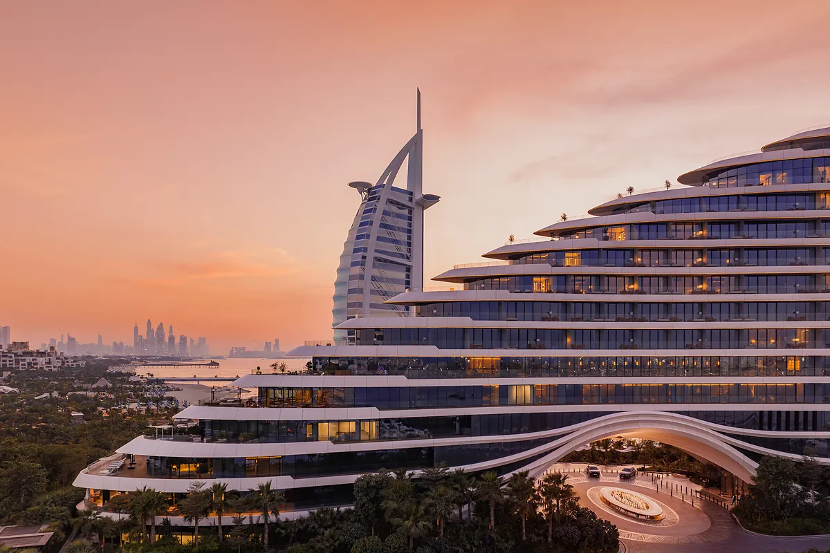 Jumeirah Marsa Al Arab at dusk with Burj Al Arab behind