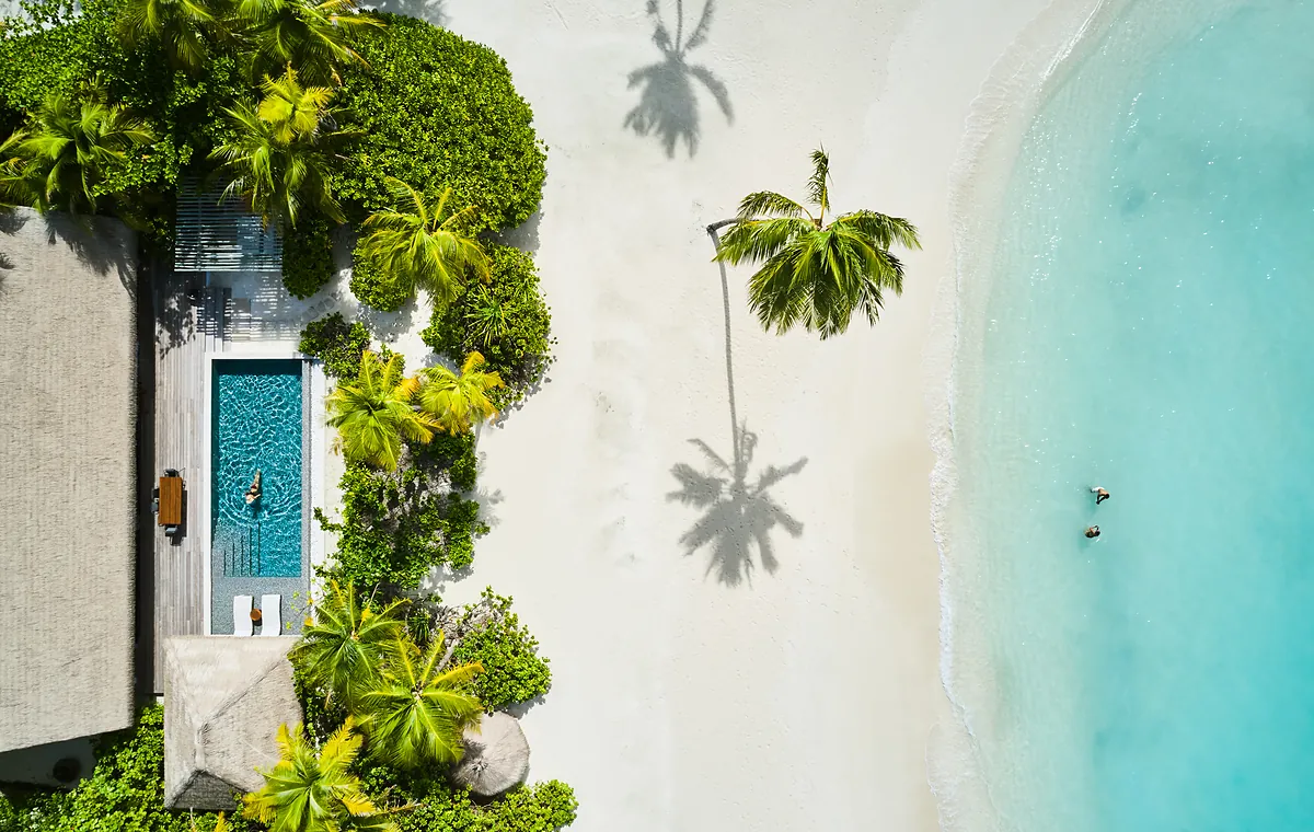 Aerial view of a beach villa and pool on the sand at Waldorf Astoria Maldives Ithaafushi
