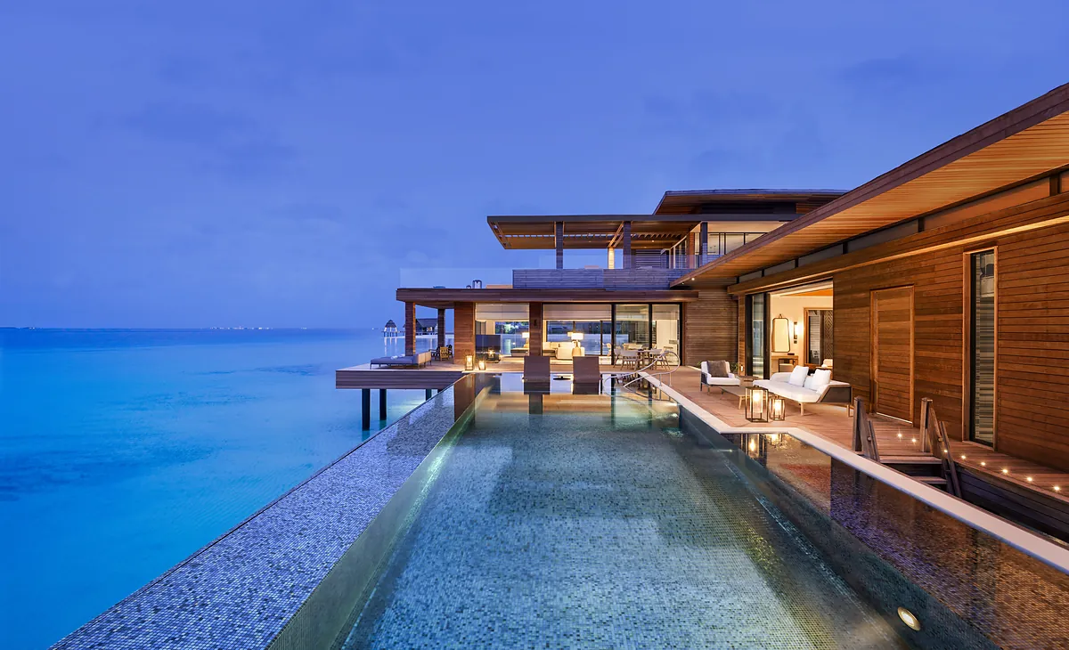 Overwater pavilion and pool at twilight, Waldorf Astoria Maldives Ithaafushi