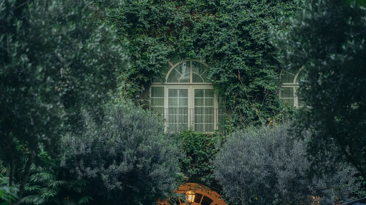 The planted hacienda courtyard at Four Seasons Hotel Mexico City in evening light