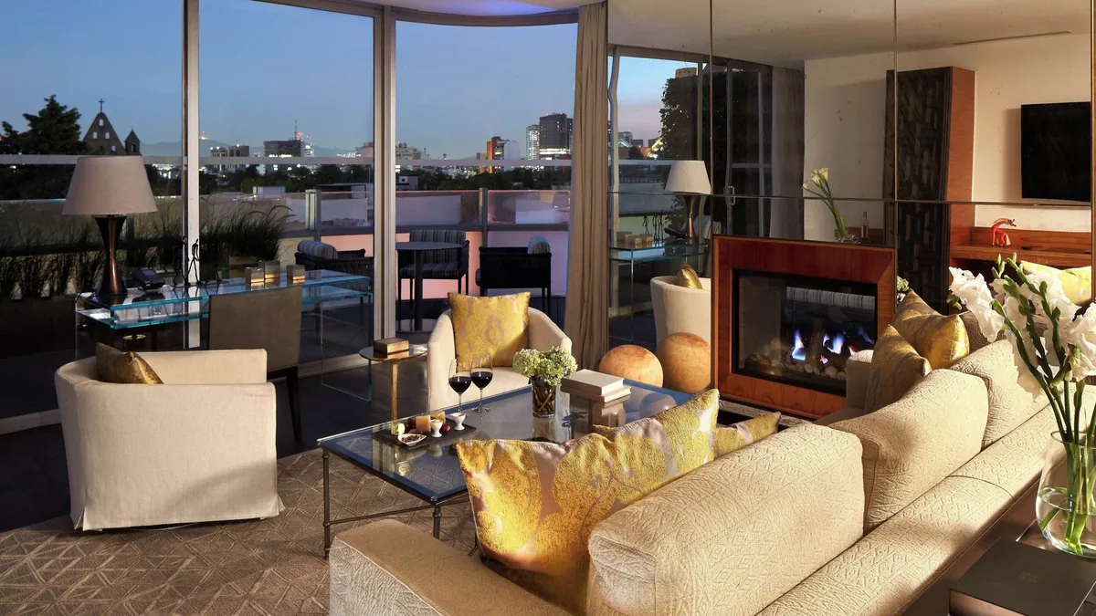 Presidential Suite living room at Las Alcobas Mexico City with Yabu Pushelberg rosewood and brass interiors