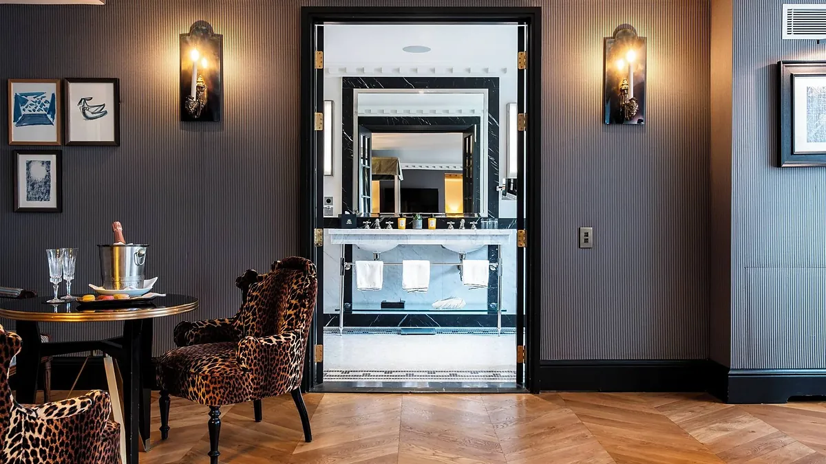 Lobby with herringbone parquet floor and antique furniture at Hôtel de Berri Paris