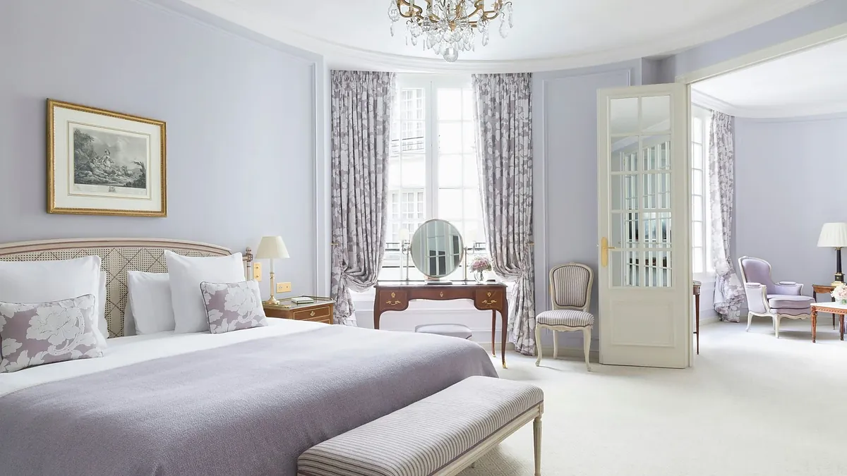 Suite bedroom with silk drapes and antiques at Le Bristol Paris