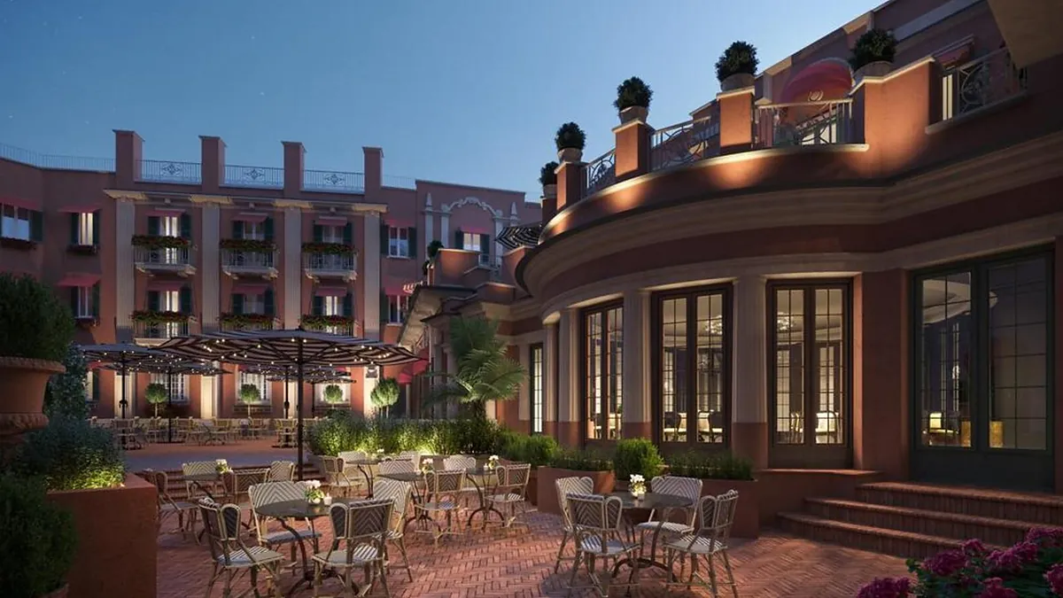 Outdoor dining terrace at Hotel de la Ville Rome under warm evening light
