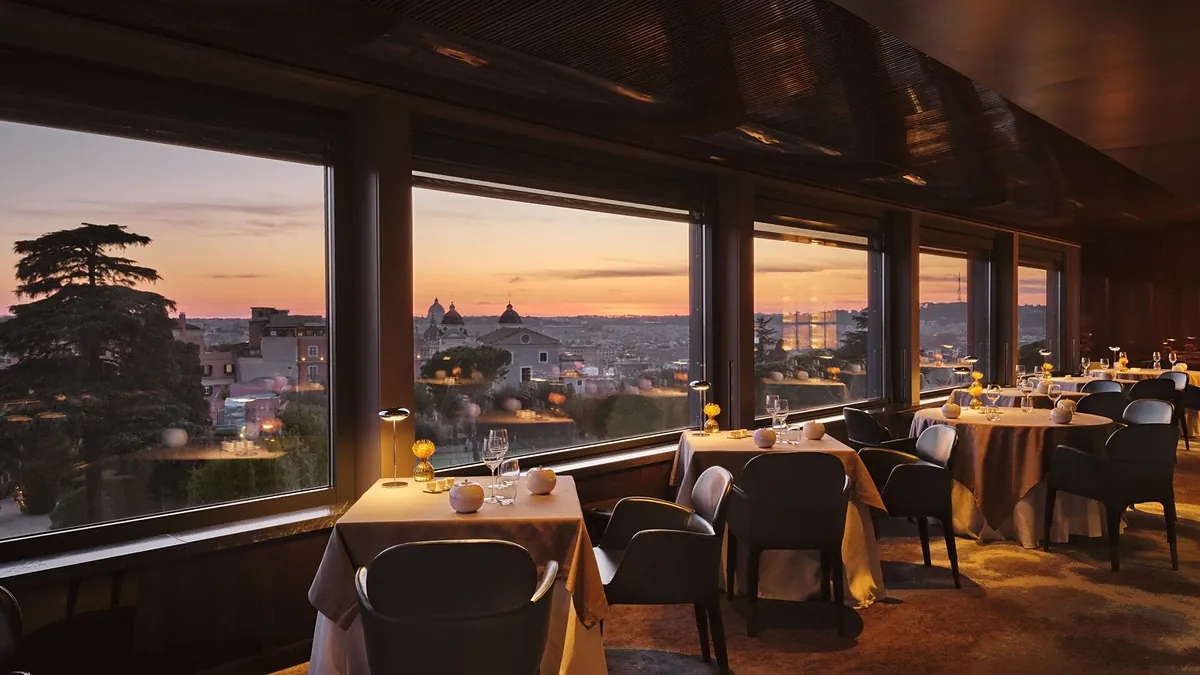 La Terrazza rooftop at Hotel Eden Rome bathed in golden sunset light