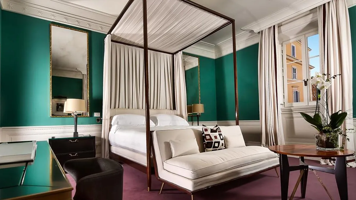 Guestroom at J.K. Place Roma with rosewood canopy bed and marble bathroom