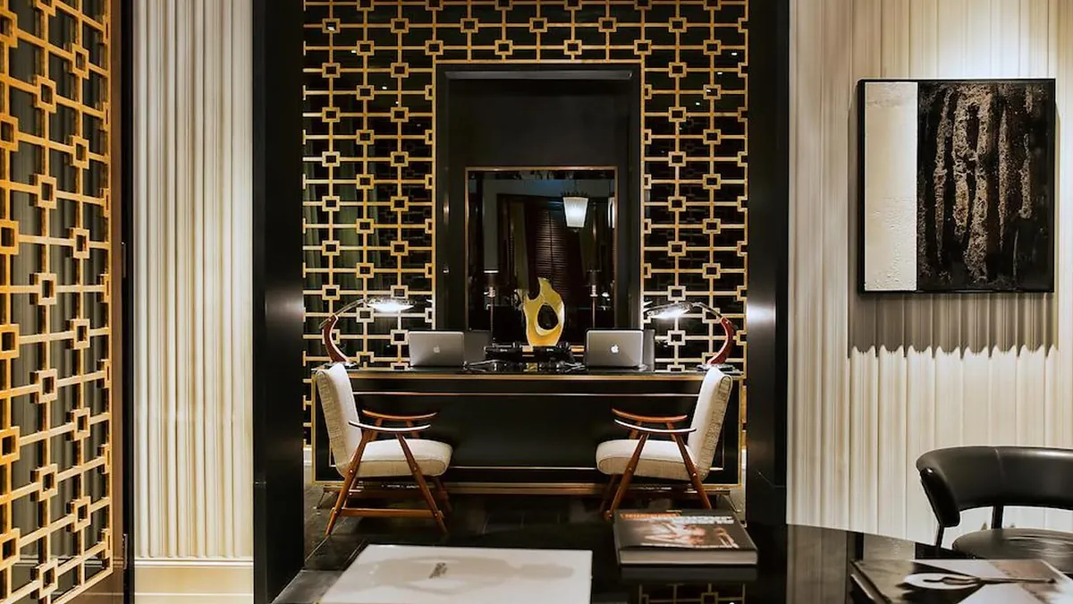 Reception at J.K. Place Roma with signature lobby fireplace and Michele Bonan interiors
