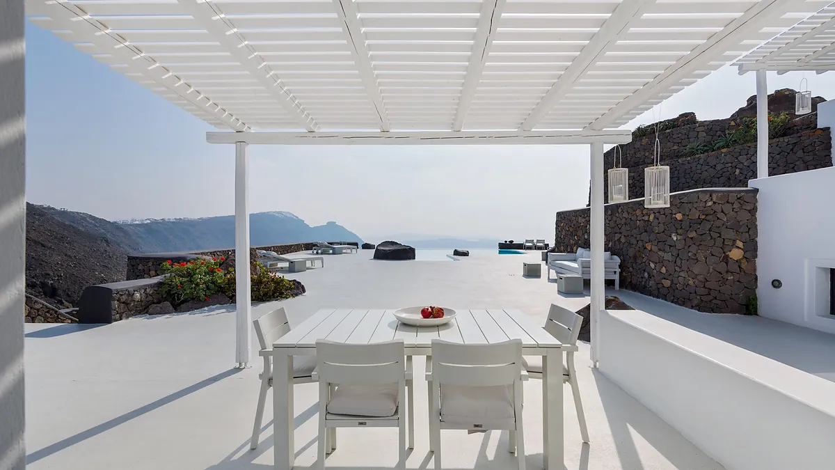 Outdoor seating sea mountain view at Aenaon Villas in Santorini