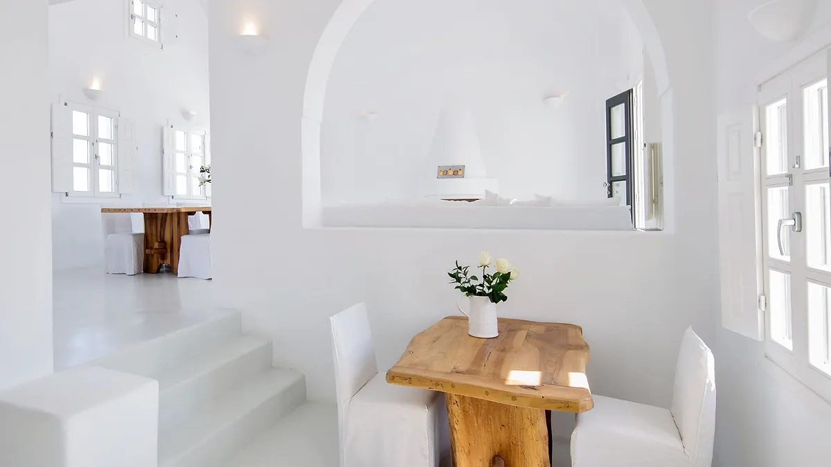 Spacious white interior dining at Aenaon Villas in Santorini