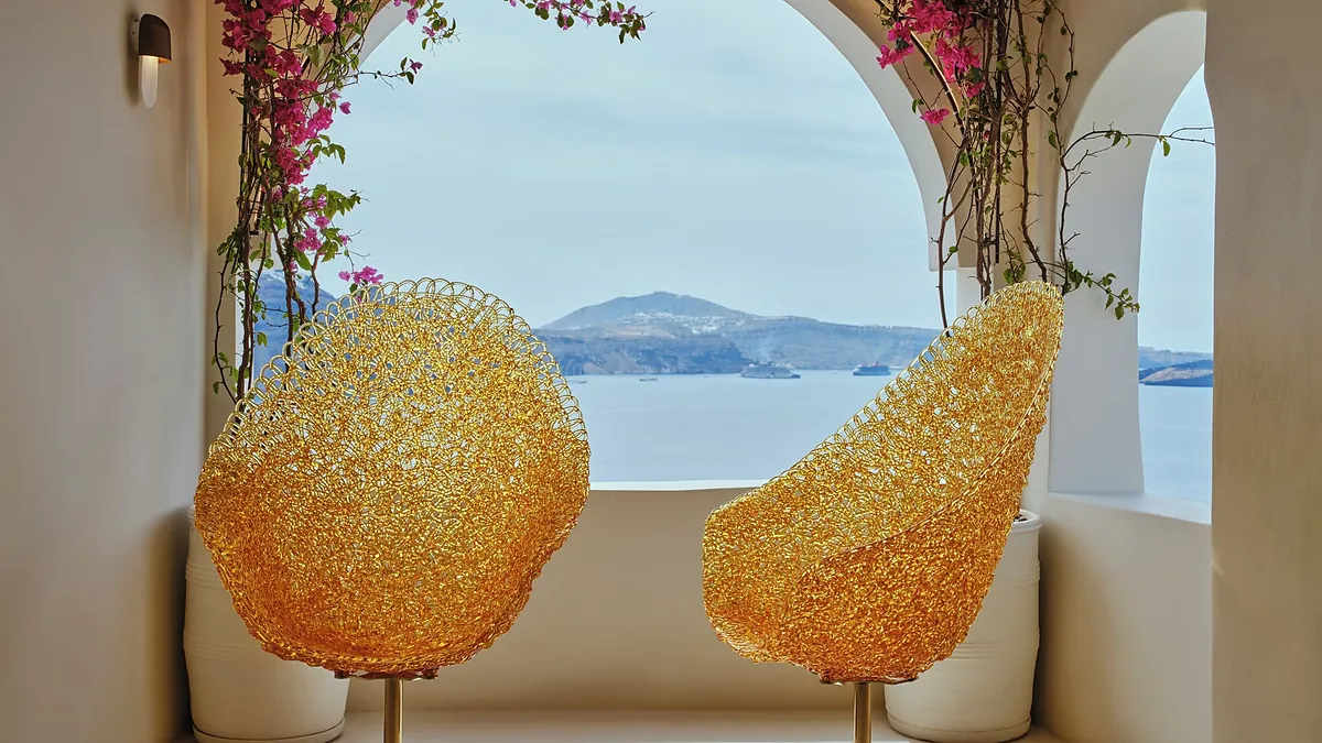 Reception golden chairs sea view at Andronis Luxury Suites in Santorini
