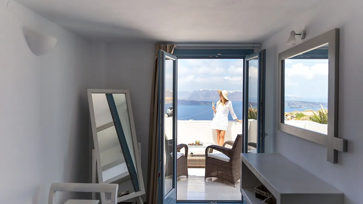 Room glass door balcony sea at Caldera Romantica in Santorini