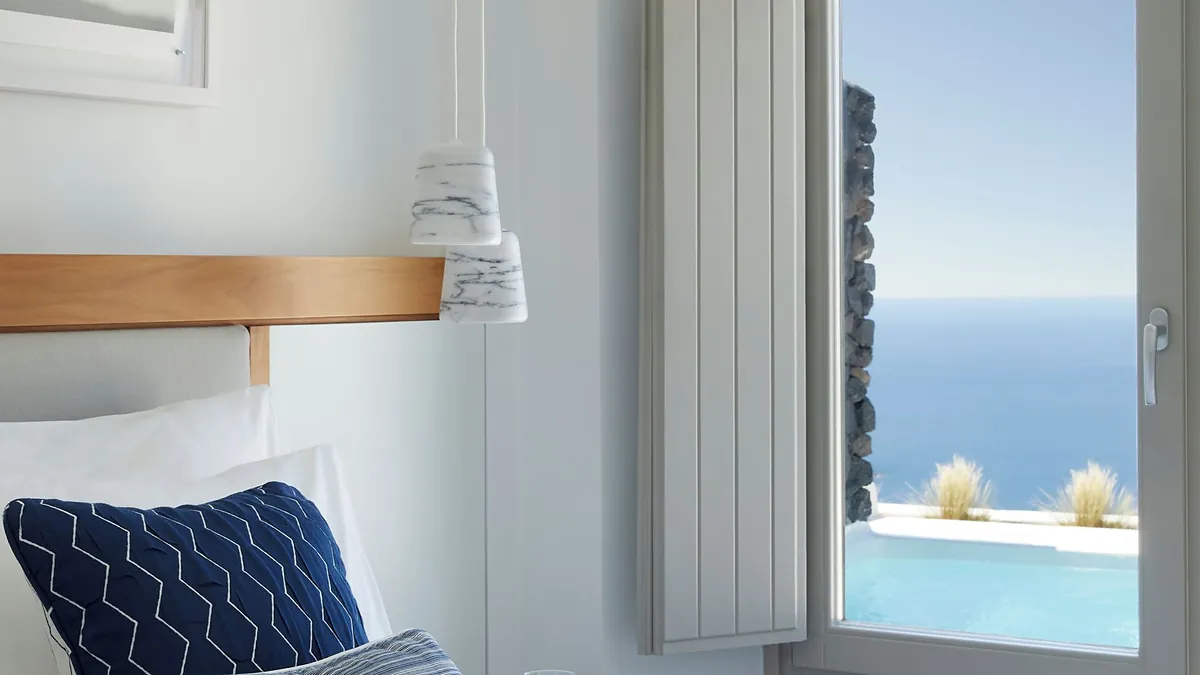 Bedroom with sea view at Grace Hotel Santorini in Santorini