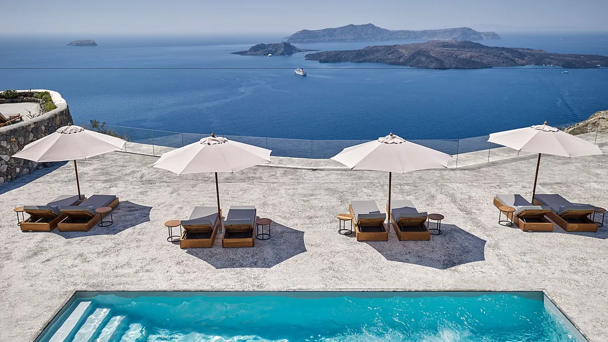 Poolside terrace with sun loungers and Aegean views at Vedema, a Luxury Collection Resort in Megalochori, Santorini