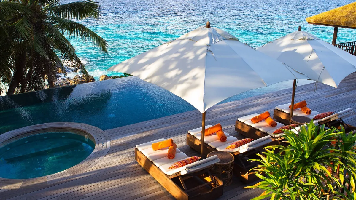 Private infinity pool set into granite boulders at Fregate Island Private, Seychelles