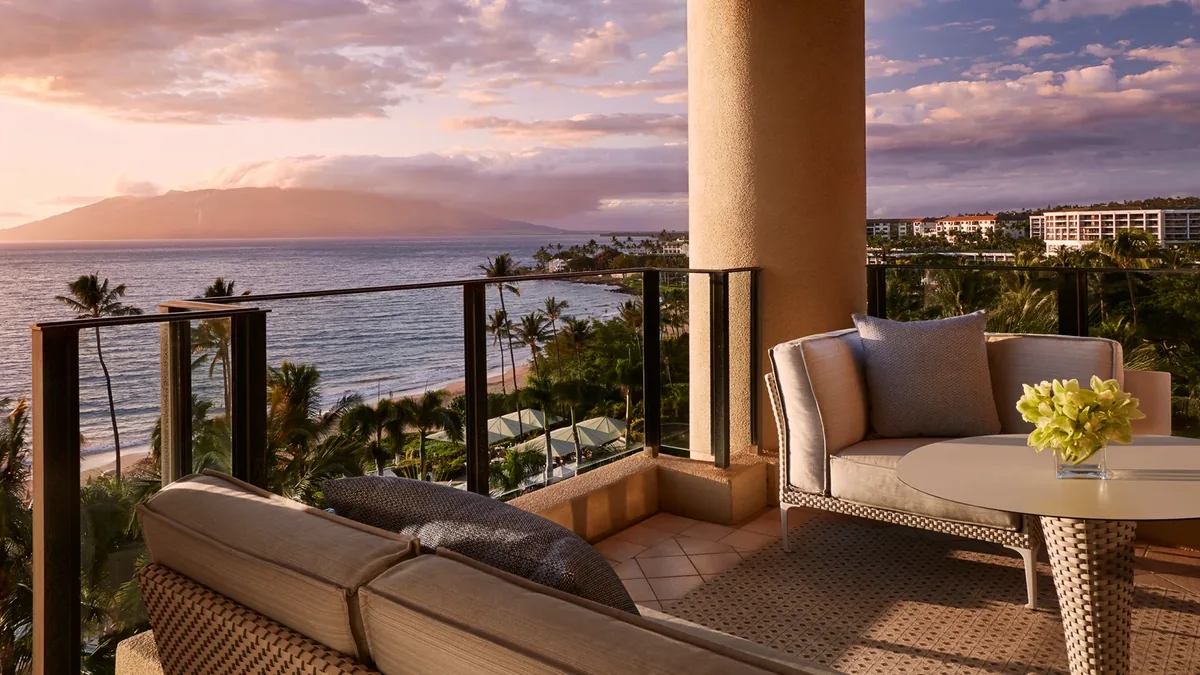 Oceanfront suite balcony at sunset over the West Maui Mountains
