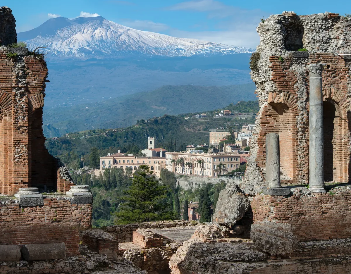 The ancient Greek Theatre of Taormina with Mount Etna behind