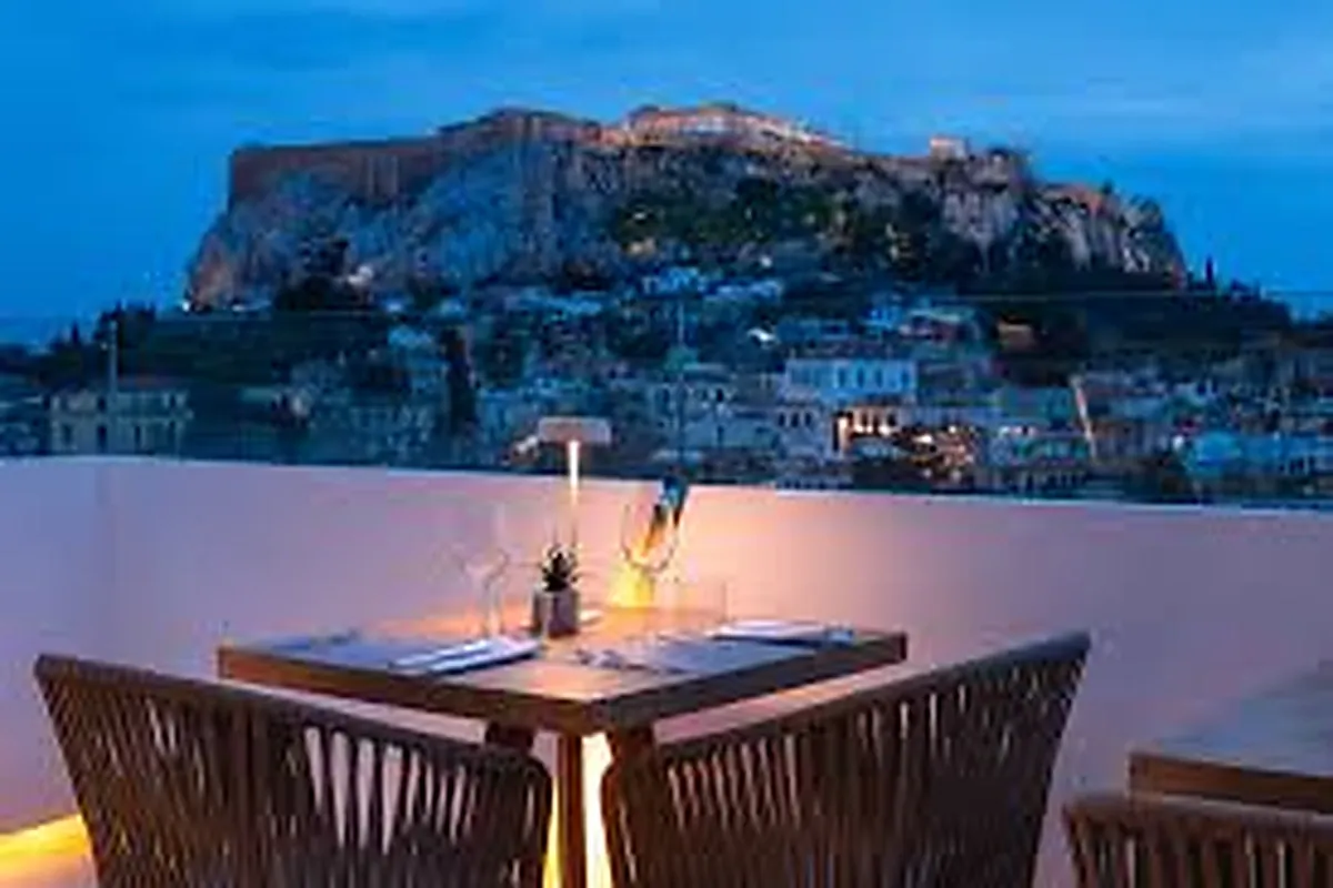 Rooftop terrace in central Athens with the floodlit Acropolis in the background