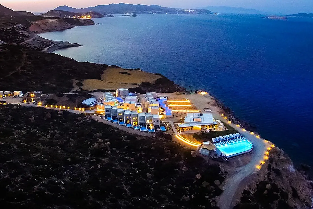 Villas terraced above a private cove with turquoise water on Milos