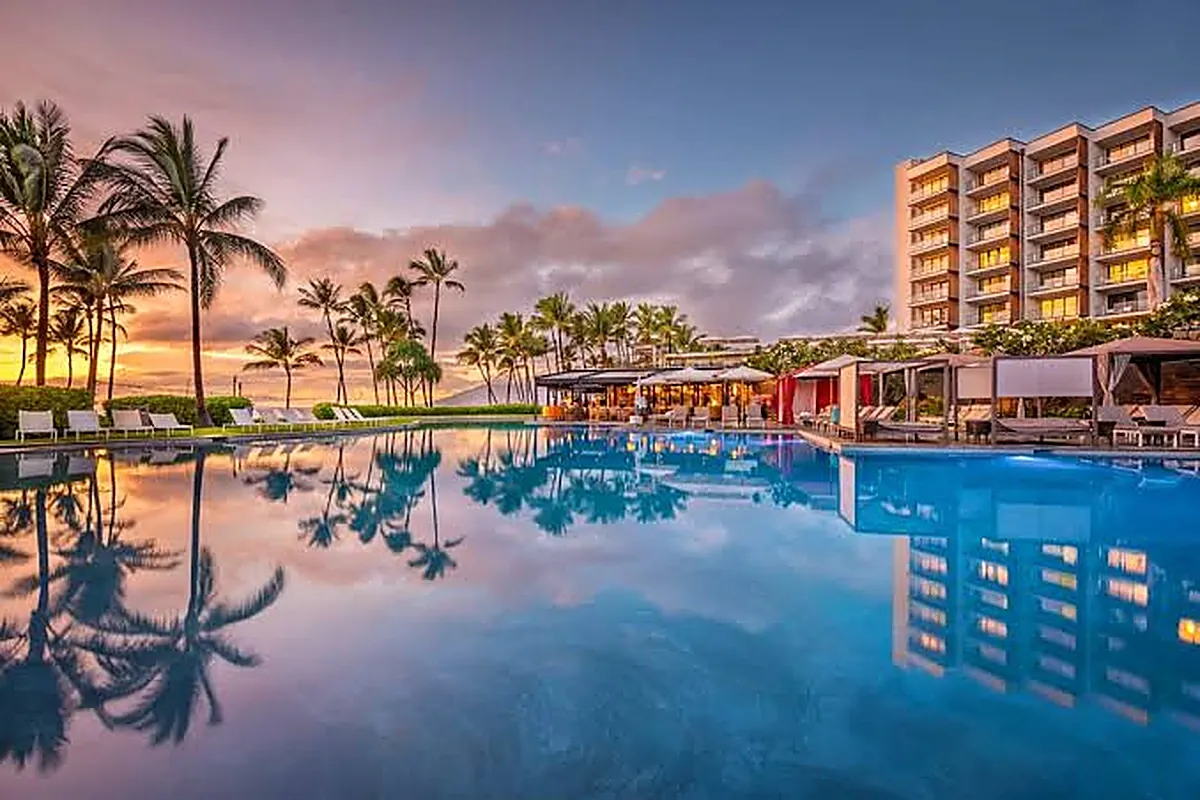 Tiered infinity pools cascading toward the ocean at a contemporary Maui resort at sunset