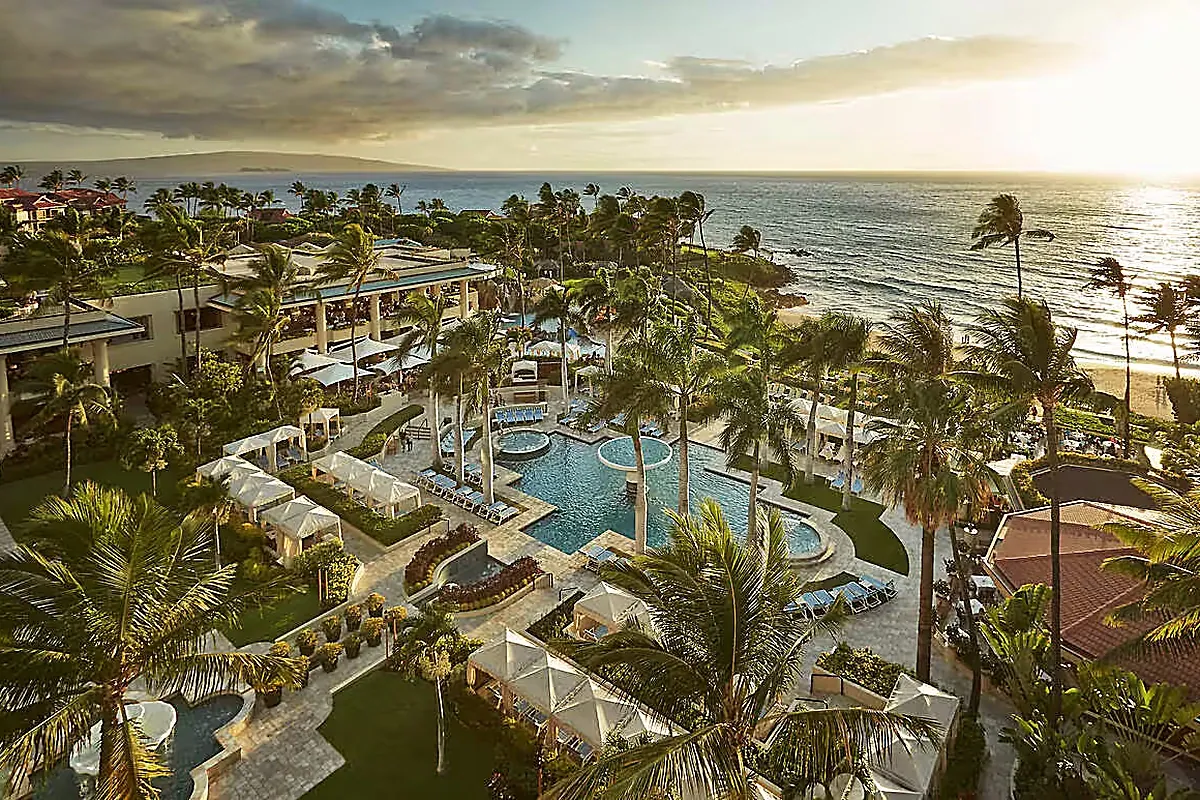 Oceanfront resort pool deck and palms above Wailea Beach on Maui