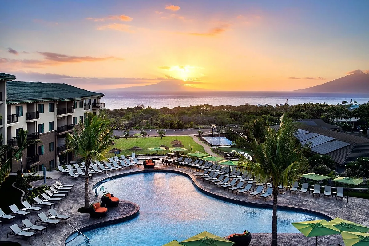 Small adults only hotel pool deck on a Maui hillside with bougainvillea and a wide ocean view