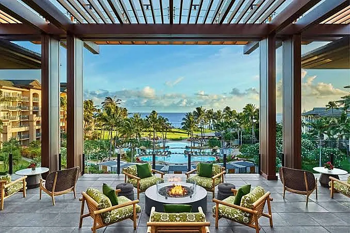 Hillside luxury resort above the ocean in West Maui with golf fairway, lawns and tall palms